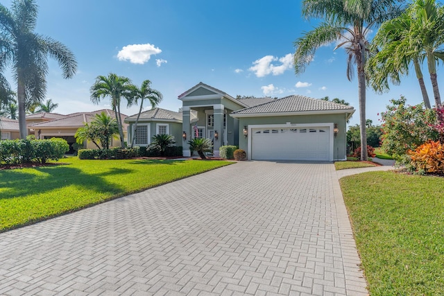 view of front facade with a garage and a front lawn