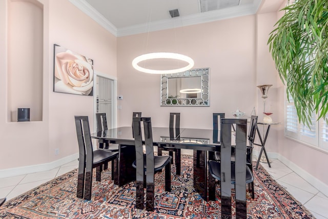 tiled dining space featuring crown molding