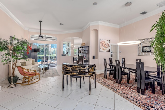 tiled dining room featuring ceiling fan and ornamental molding