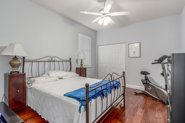 bedroom with dark hardwood / wood-style flooring, a closet, and ceiling fan