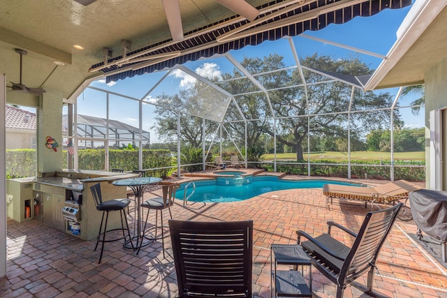 view of pool featuring exterior bar, a lanai, a patio, and an in ground hot tub