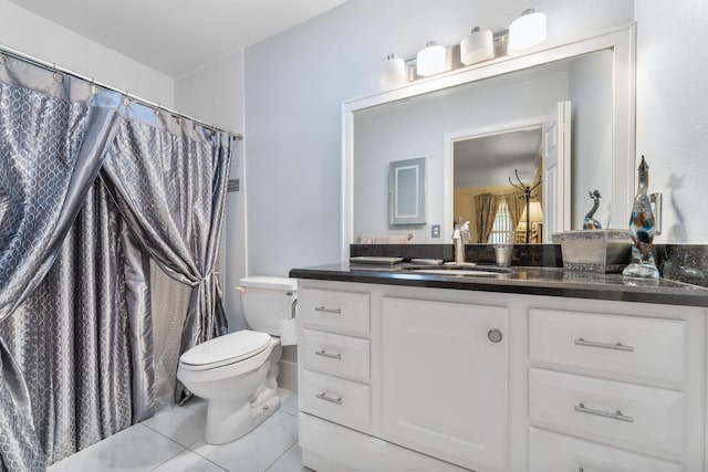 bathroom featuring tile patterned flooring, vanity, and toilet