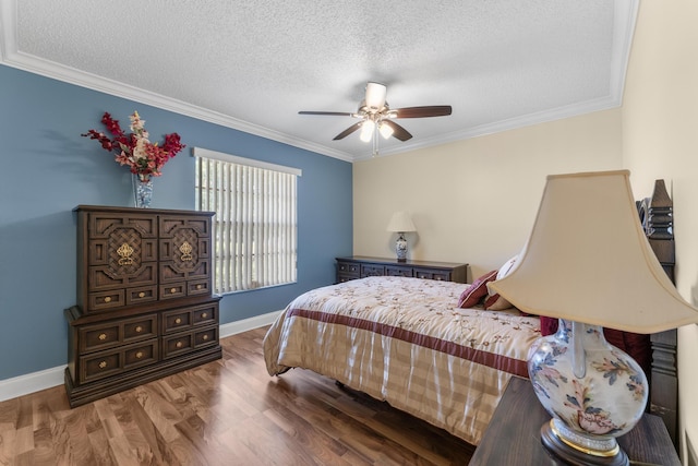 bedroom featuring ceiling fan, crown molding, and a textured ceiling