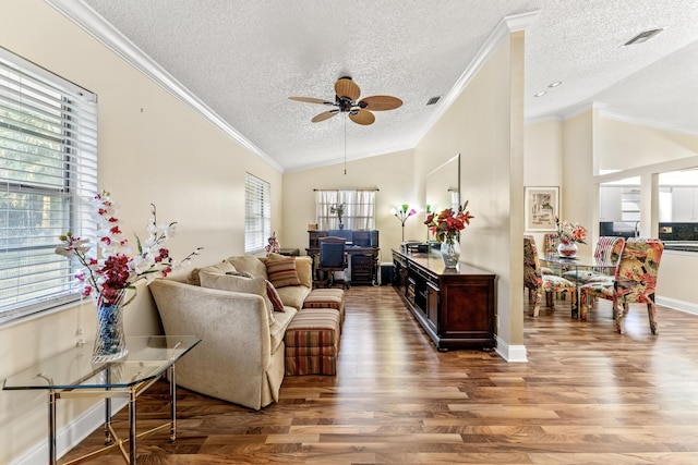 living room with ornamental molding, a textured ceiling, ceiling fan, hardwood / wood-style flooring, and lofted ceiling