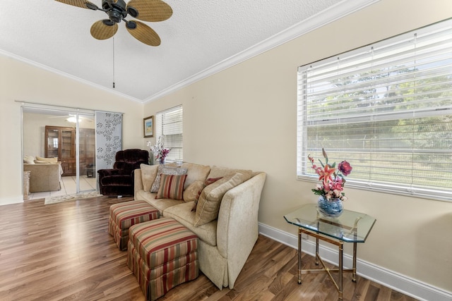 living room featuring crown molding, hardwood / wood-style floors, ceiling fan, and a healthy amount of sunlight