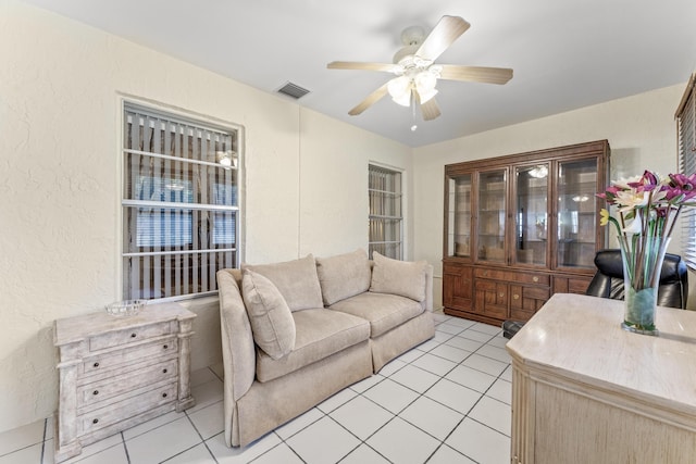 tiled living room with ceiling fan