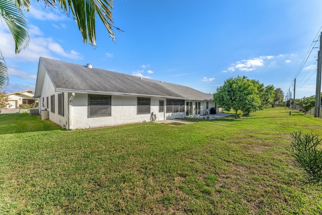 back of property featuring a yard