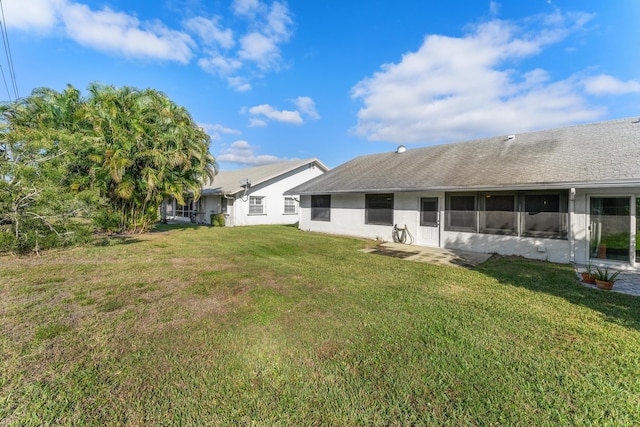 rear view of property with a yard