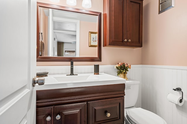 bathroom with vanity and toilet