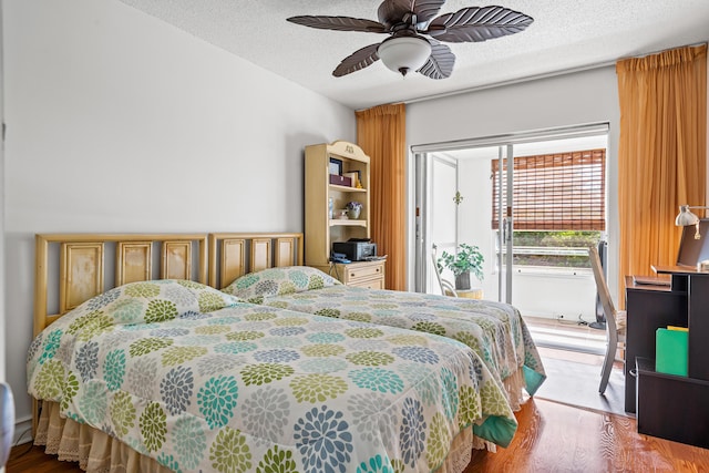 bedroom with ceiling fan, light hardwood / wood-style floors, a textured ceiling, and access to outside