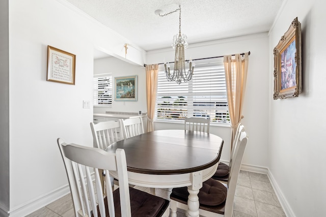 tiled dining room with crown molding, a textured ceiling, and an inviting chandelier