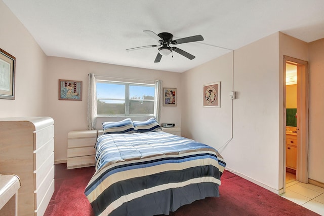 carpeted bedroom featuring ensuite bath and ceiling fan