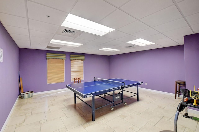 rec room with a paneled ceiling and light tile patterned floors