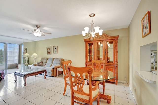 tiled dining area featuring ceiling fan with notable chandelier