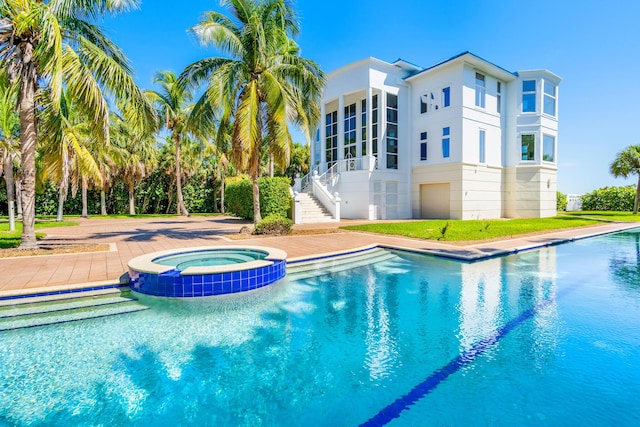 view of pool featuring an in ground hot tub