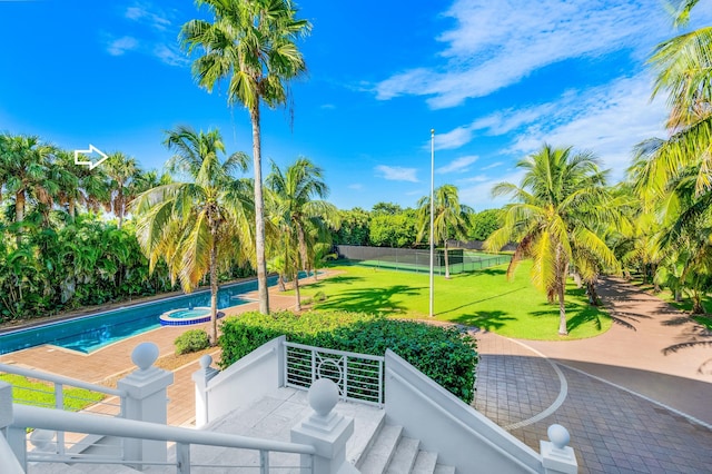 view of swimming pool with a yard and a patio