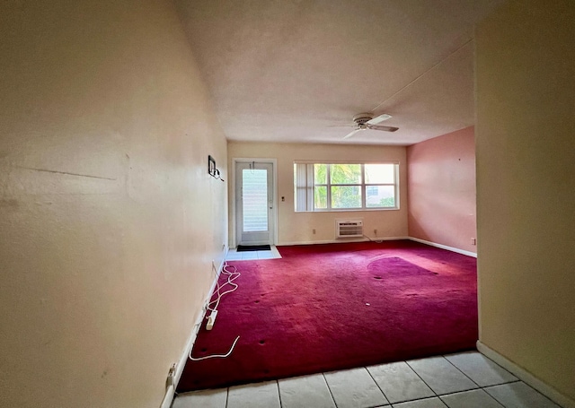 unfurnished room featuring light tile patterned floors, an AC wall unit, and ceiling fan