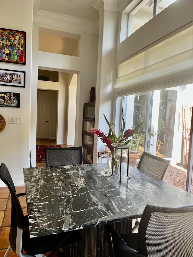 dining space featuring crown molding