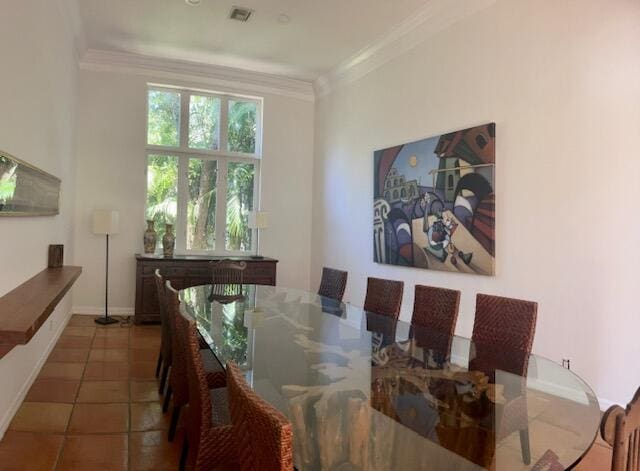 dining area with tile patterned flooring and ornamental molding