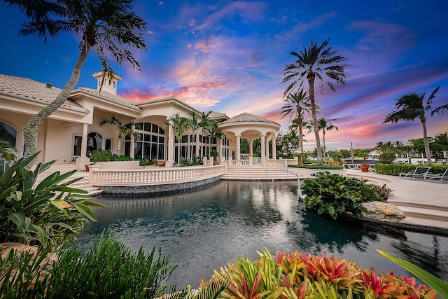 view of pool at dusk