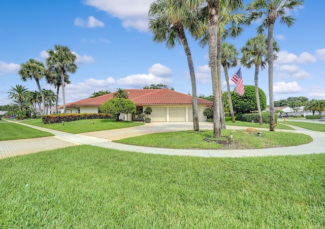 view of front facade with a garage and a front lawn