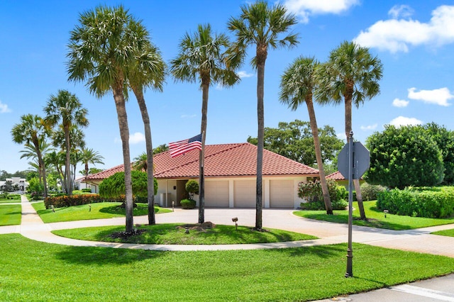 4246 Live Oak Blvd, Delray Beach, FL 33445 - mediterranean / spanish house with a tile roof, a front lawn, stucco siding, and a garage