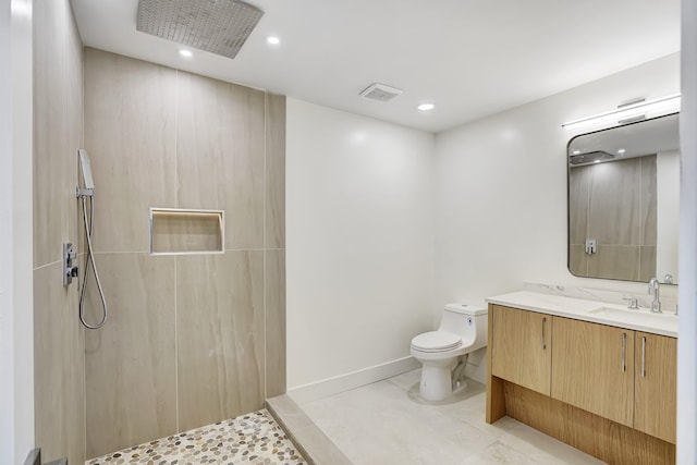 bathroom with tile patterned flooring, vanity, toilet, and a shower