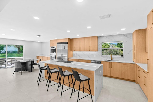 4246 Live Oak Blvd, Delray Beach, FL 33445 - kitchen featuring stainless steel appliances, a sink, plenty of natural light, a breakfast bar, and recessed lighting