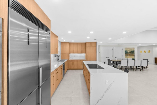 4246 Live Oak Blvd, Delray Beach, FL 33445 - kitchen with black appliances, modern cabinets, a kitchen island, light brown cabinets, and recessed lighting