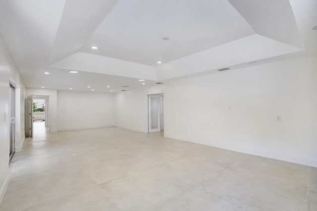 spare room featuring a tray ceiling