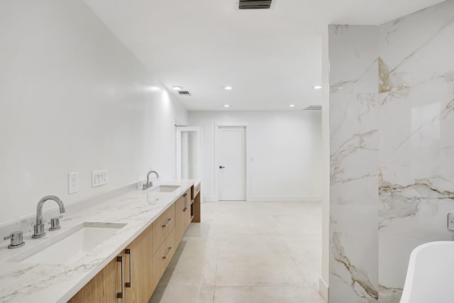 bathroom with a tub to relax in and vanity