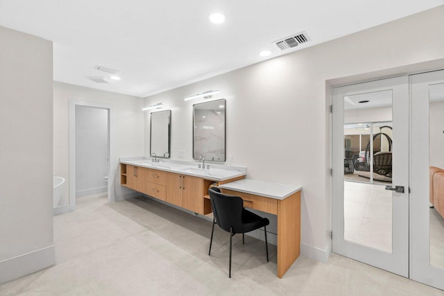 4246 Live Oak Blvd, Delray Beach, FL 33445 - full bathroom with toilet, double vanity, baseboards, and recessed lighting