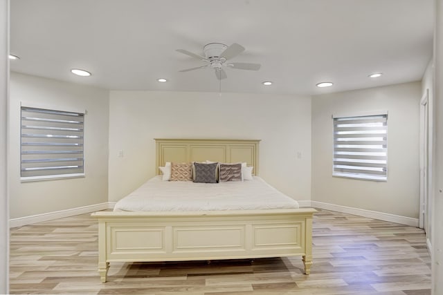 bedroom with light hardwood / wood-style flooring and ceiling fan