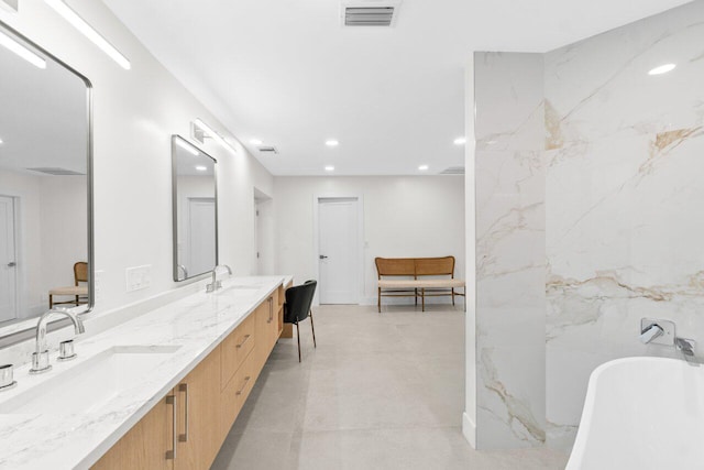4246 Live Oak Blvd, Delray Beach, FL 33445 - full bath featuring double vanity, a soaking tub, recessed lighting, and concrete flooring