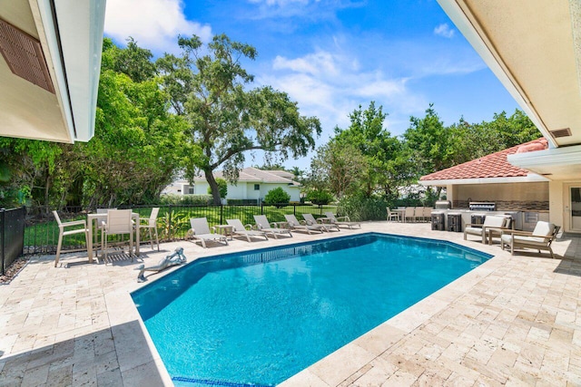 4246 Live Oak Blvd, Delray Beach, FL 33445 - view of pool featuring an outdoor kitchen, a patio area, and outdoor dining space
