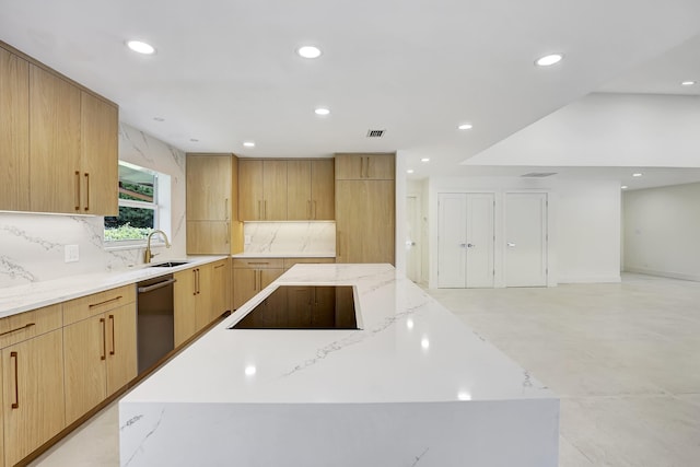 kitchen with light stone countertops, black electric stovetop, stainless steel dishwasher, light brown cabinets, and a large island