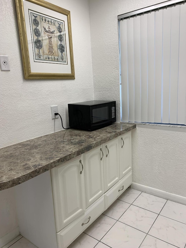 bathroom with tile patterned flooring and vanity