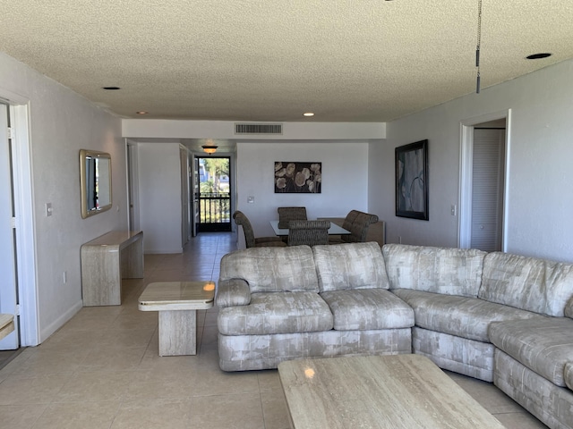 tiled living room with a textured ceiling