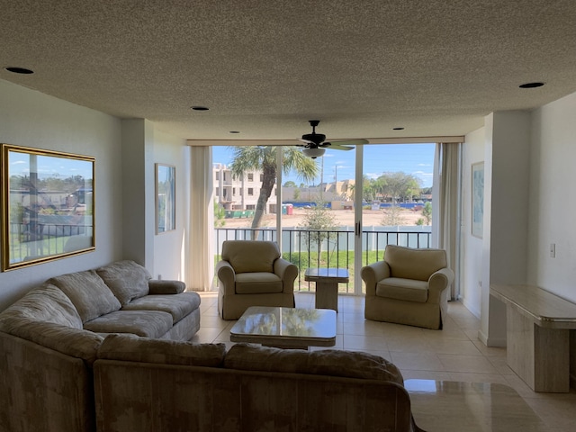 tiled living room featuring ceiling fan and a textured ceiling