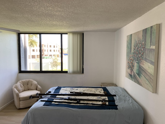 bedroom featuring a textured ceiling and light wood-type flooring