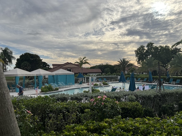 pool at dusk with a patio