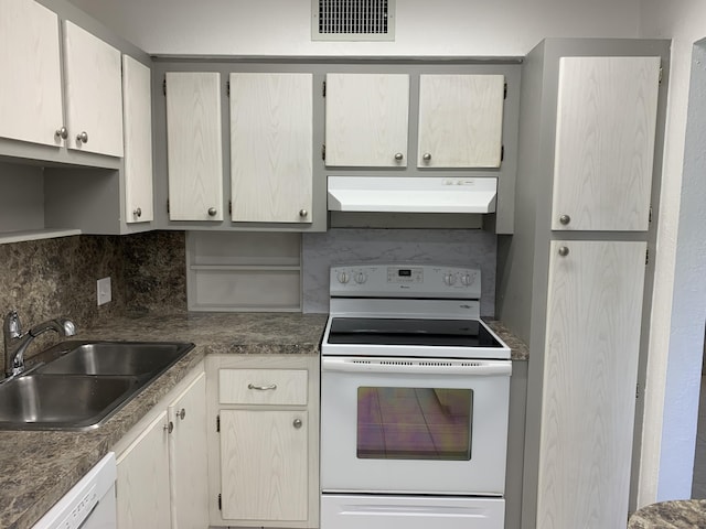 kitchen with tasteful backsplash, sink, and white appliances