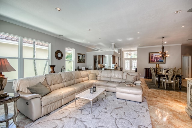 tiled living room with ornamental molding and an inviting chandelier