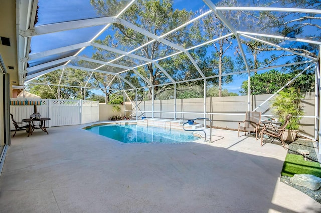 view of pool with a patio area and a lanai