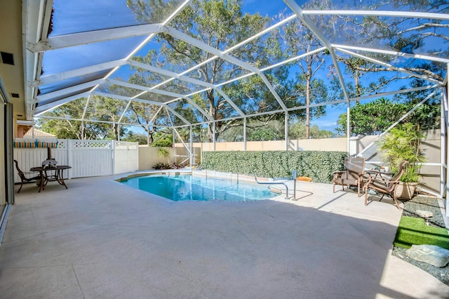 view of pool with a fenced in pool, a lanai, a patio area, and a fenced backyard