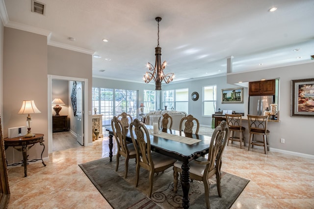 dining room featuring a notable chandelier and ornamental molding