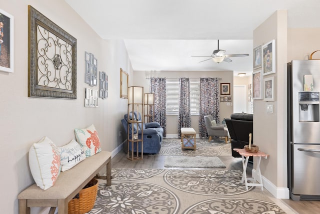 living room with hardwood / wood-style flooring and ceiling fan