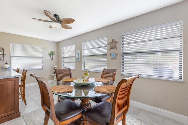 dining space with ceiling fan and light tile patterned flooring