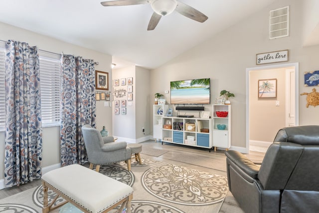 living room with light wood-type flooring, high vaulted ceiling, and ceiling fan