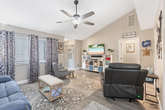 living room featuring light wood-type flooring, high vaulted ceiling, and ceiling fan